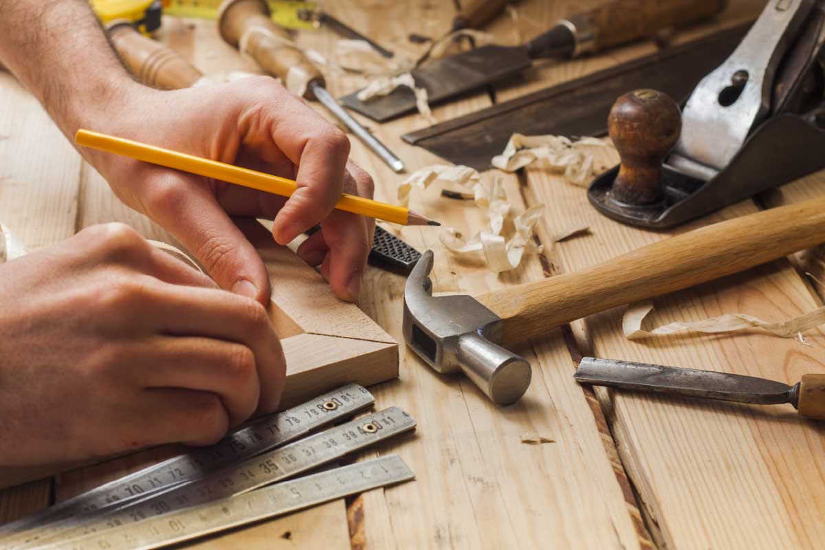 Carpenter working with tools on hand